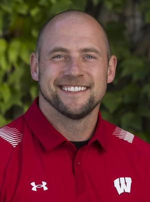 Kevin Schultz's profile picture. A white man in a red Wisconsin Badgers polo smiles at the camera in front of a green background.