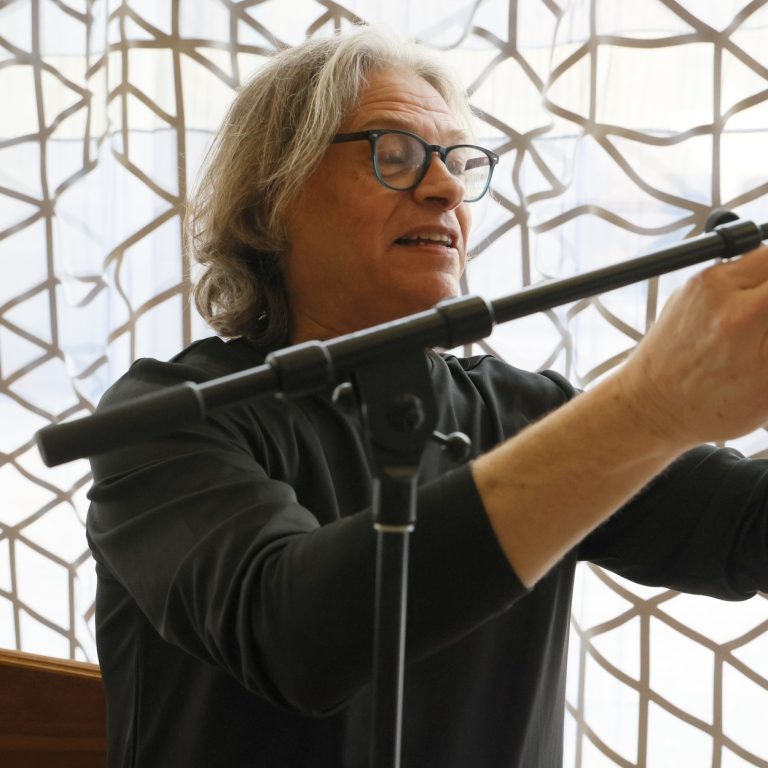 Buzz Kemper setting up a microphone for a performance.