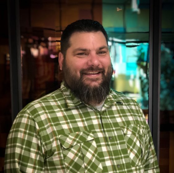 Neil Klemme's profile picture. A bearded white man with dark hair and a green plaid shirt smiles at the camera.