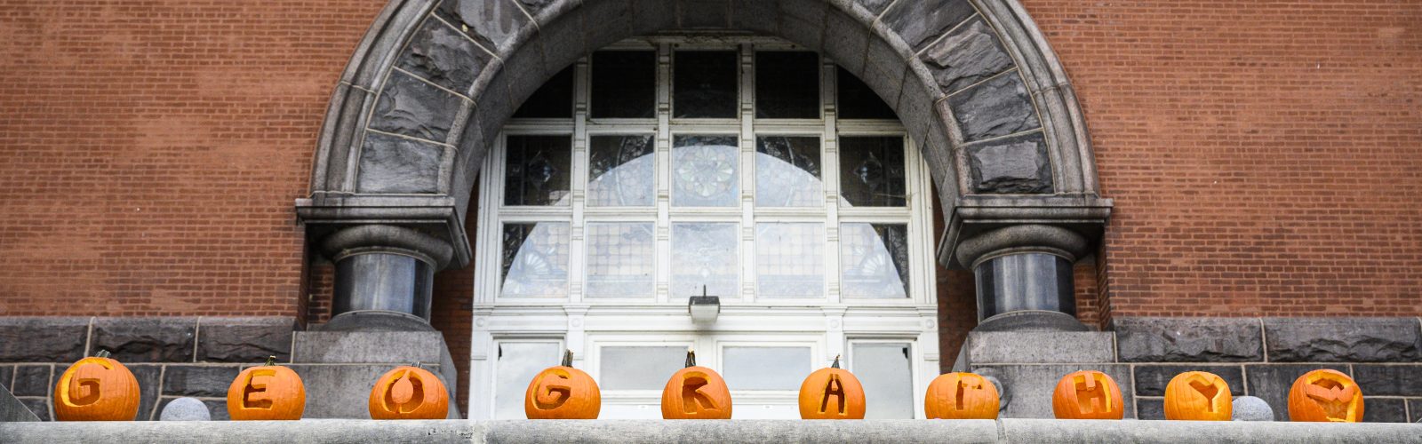 Carved pumpkins spell out GEOGRAPHY in front of Science Hall during a fall day on the University of Wisconsin-Madison campus on Oct. 20, 2021. (Photo by Althea Dotzour / UW-Madison)
