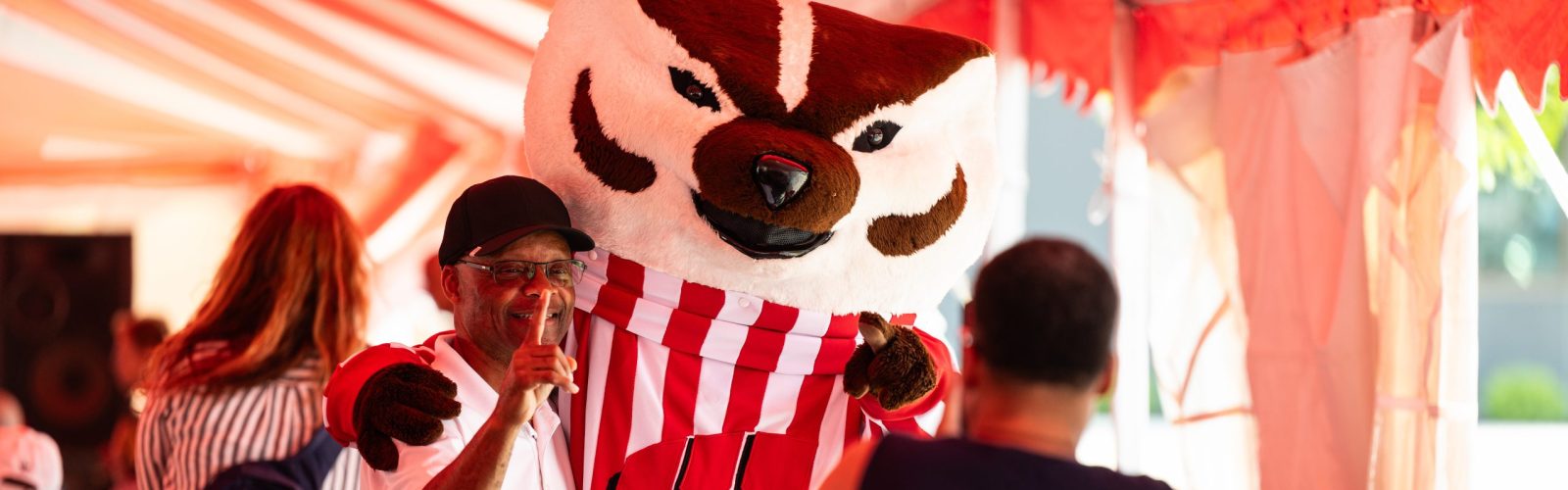 UW–Madison mascot Bucky Badger poses for a photo with an attendee during the 9th Annual Unity Picnic held outside the new Black Business Hub at The Village on Park Street in Madison, Wis., on July 22, 2023.